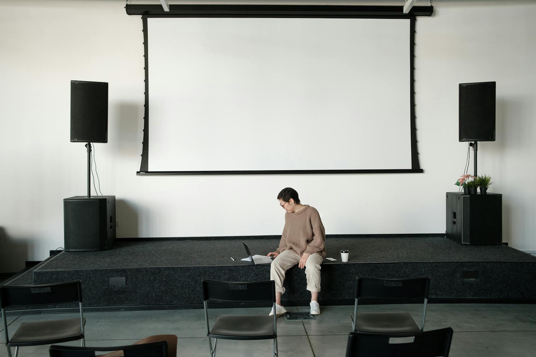 Person preparing a slideshow workflow on a laptop